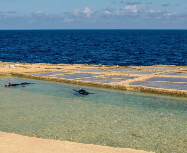 Two freedivers relaxing for static in salt pans