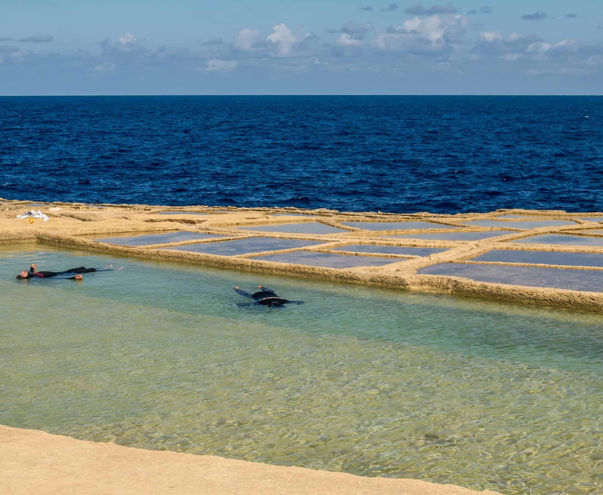 Two freedivers relaxing for static in salt pans