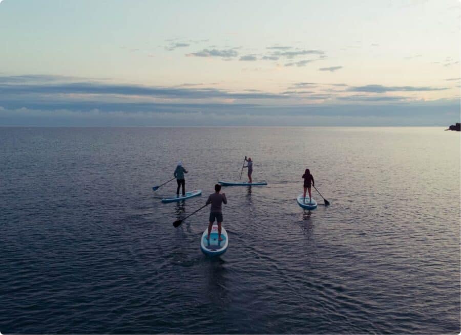 Four persons on SUP board