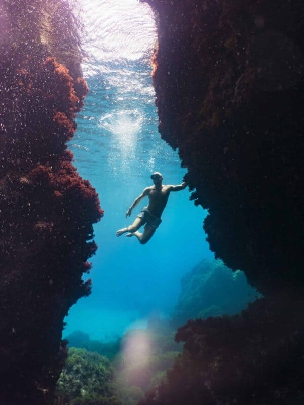 No suit freediver exploring reef