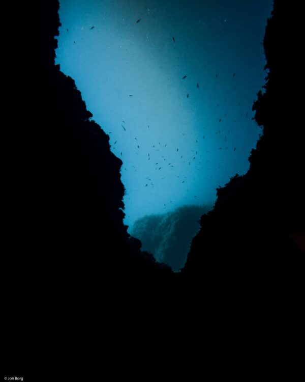 Silhouette of rocks in a V shaped form with light in the backgroubd.