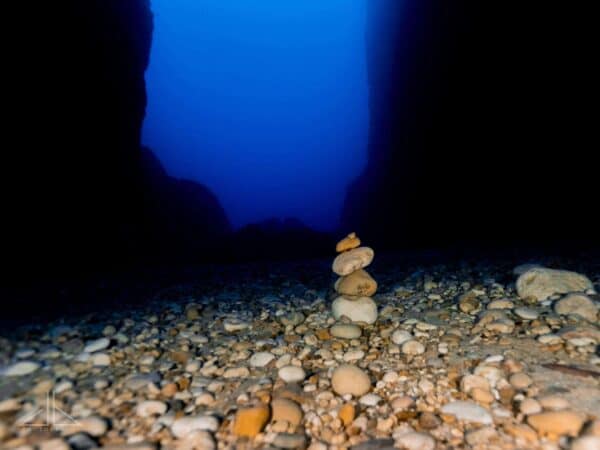 Stacked pebbles with dark background walls