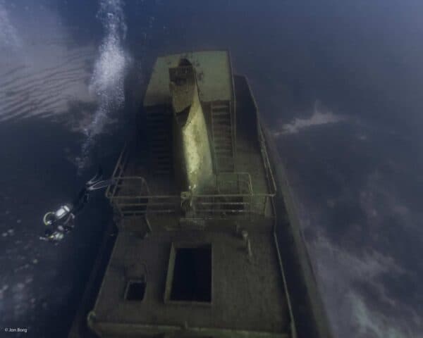 SCUBA diver exploring midway section of Tug 2 wreck