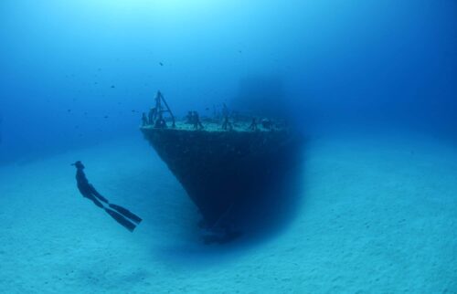 Freediver observing bow of P31 wreck