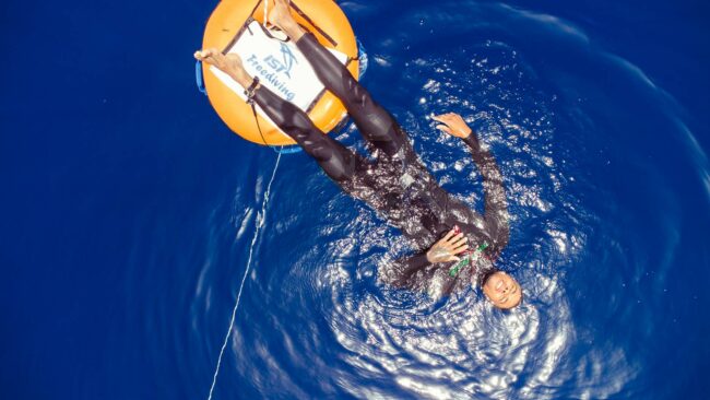 Freediver lies down on his back, soaking up the sun