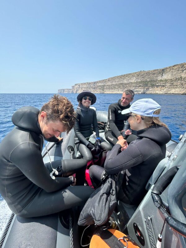 Freedivers sitting on a boat